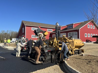 Paving train laying surface at the red-barn building.