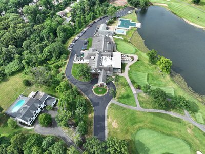 Overhead aerial of the clubhouse, entrance circle, and newly paved drive at Rock Spring.