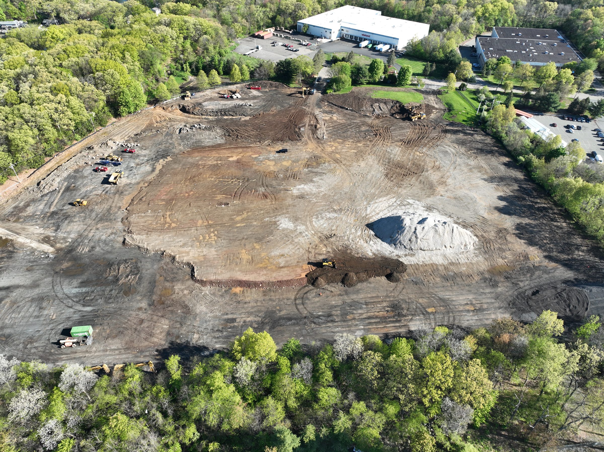 Aerial drone view of the active warehouse jobsite in Parsippany, NJ — mass earthwork in progress.
