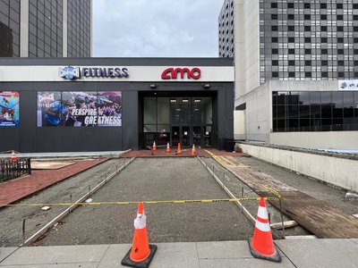 Forms staked along storefront entrance preparing subgrade for new concrete sidewalk pour